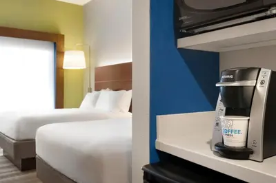 a hotel room with a coffee maker and a bed at Holiday Inn Express & Suites - Cincinnati South - Wilder by IHG in Wilder