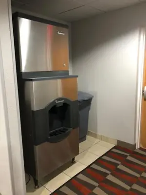 a room with a fireplace in the corner of a room at Microtel Inn & Suites by Wyndham Pittsburgh Airport in Robinson Township