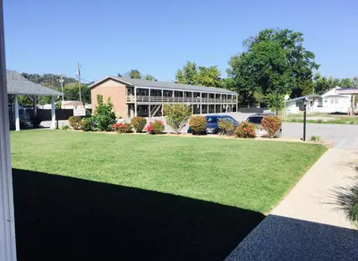a house with a lawn in front of a building at Brown's Motel in Aberdeen