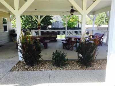 a patio with tables and chairs on a porch at Brown's Motel in Aberdeen