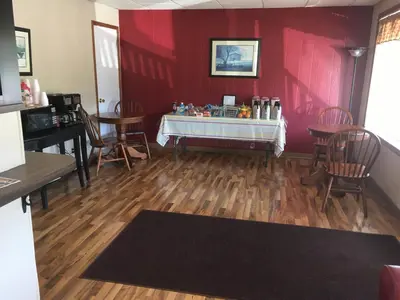 a room with red walls and wooden floors and chairs at Brown's Motel in Aberdeen