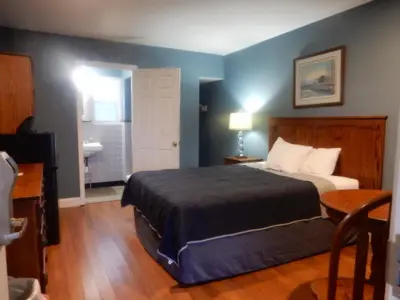 a hotel room with a bed and a bathroom at Brown's Motel in Aberdeen