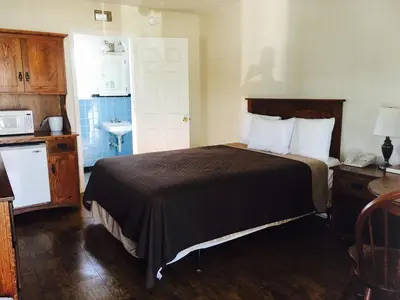 a hotel room with a bed and a sink at Brown's Motel in Aberdeen