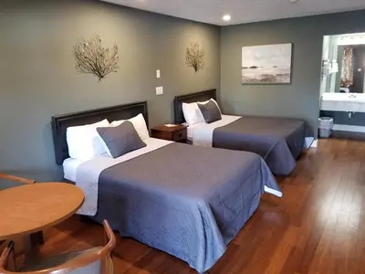 a hotel room with two beds and a table at Brown's Motel in Aberdeen