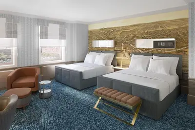 a hotel room with two beds and a chair at Hotel Cleveland Autograph Collection in Cleveland