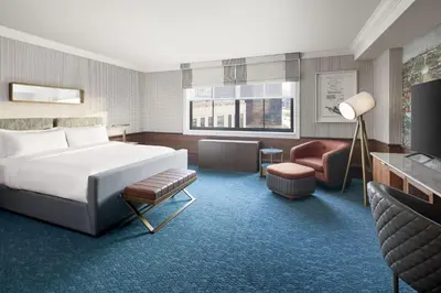 a hotel room with a bed and a living area at Hotel Cleveland Autograph Collection in Cleveland