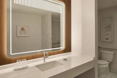 a bathroom with a sink and a mirror at Hotel Cleveland Autograph Collection in Cleveland