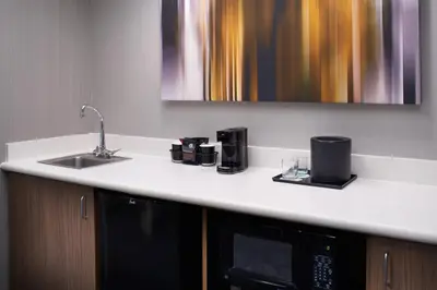 a kitchen counter with a sink and a microwave at Courtyard Cleveland Airport North in North Olmsted