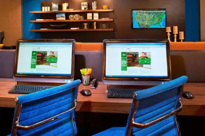 two laptop computers sitting on a wooden desk at Courtyard Cleveland Airport North in North Olmsted