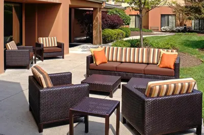 a group of chairs and couches on a patio at Courtyard Cleveland Airport North in North Olmsted