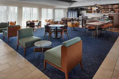 a restaurant with tables and chairs and a bar at Courtyard Columbus Dublin in Dublin