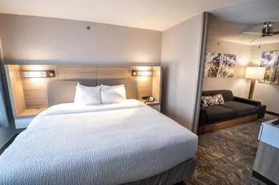 a hotel room with a large bed and a couch at SpringHill Suites Columbus Airport Gahanna in Gahanna