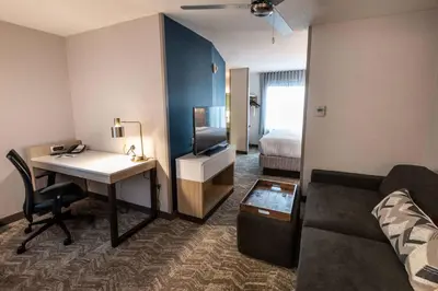 a hotel room with a desk and a bed at SpringHill Suites Columbus Airport Gahanna in Gahanna
