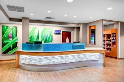 a lobby with a blue counter in a library at SpringHill Suites Columbus Airport Gahanna in Gahanna
