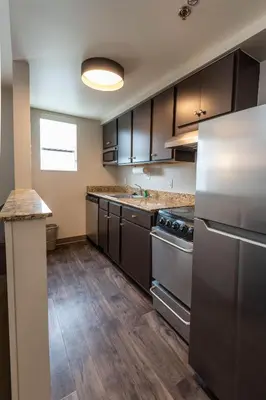 a kitchen with stainless steel appliances and wooden floors at TownePlace Suites Columbus Airport Gahanna in Gahanna