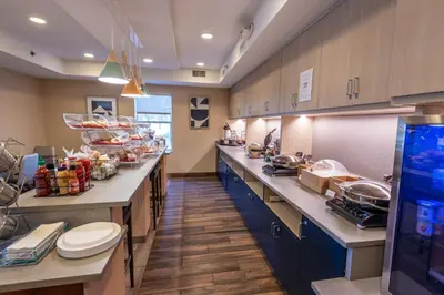 a large kitchen with a long line of counters at TownePlace Suites Columbus Airport Gahanna in Gahanna