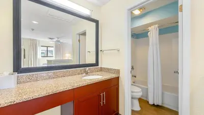 a bathroom with a sink and a mirror and a toilet at Sonesta ES Suites Cincinnati - Sharonville West in Sharonville