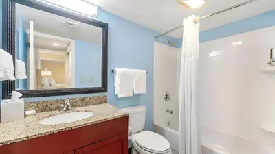 a bathroom with a sink and a toilet and a mirror at Sonesta ES Suites Cincinnati - Sharonville West in Sharonville