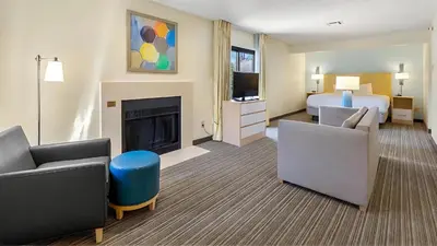a hotel room with a bed and a fireplace at Sonesta ES Suites Cincinnati - Sharonville West in Sharonville