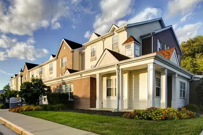 a large house on the side of a street at Hawthorn Extended Stay by Wyndham Cincinnati NE Mason in Mason