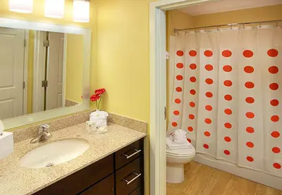 a bathroom with a sink and a toilet and a shower at Hawthorn Extended Stay by Wyndham Cincinnati NE Mason in Mason