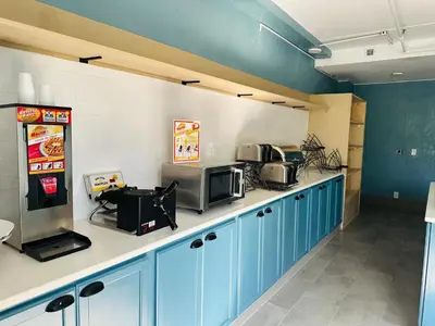 a kitchen with blue cabinets and a popcorn machine at Townhouse Near Hall Of Fame Canton I 77 in Canton
