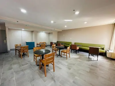 a waiting room with tables and chairs in a building at Townhouse Near Hall Of Fame Canton I 77 in Canton