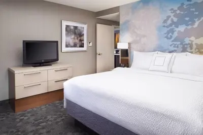 a hotel room with a bed and a tv at Courtyard Cleveland Independence in Independence