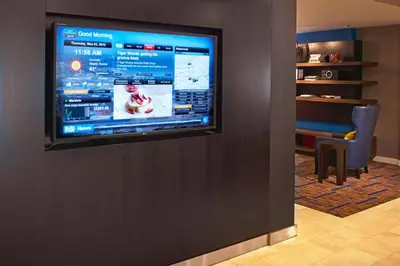 a flat screen tv on a wall in a room at Courtyard Cleveland Independence in Independence