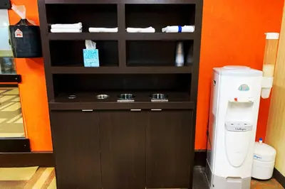 a cupboard with a drink dispenser next to a drink at Courtyard by Marriott Cleveland Westlake in Westlake
