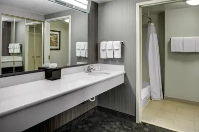 a bathroom with a sink and a mirror at Courtyard by Marriott Cleveland Westlake in Westlake
