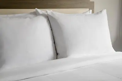 two white pillows sitting on top of a bed at Courtyard by Marriott Cleveland Westlake in Westlake