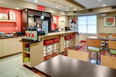 a fast food restaurant with red walls and tables and chairs at Towneplace Suites by Marriott Cleveland Westlake in Westlake