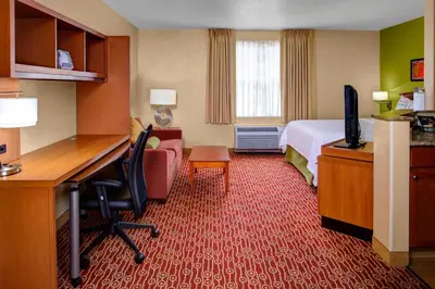 a hotel room with a bed and a desk with a computer at Towneplace Suites by Marriott Cleveland Westlake in Westlake