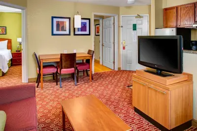 a living room with a flat screen tv on a cabinet at Towneplace Suites by Marriott Cleveland Westlake in Westlake