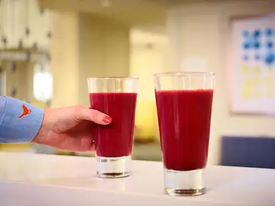 a person holding a glass of red juice at Sonesta Simply Suites Dublin Columbus in Dublin