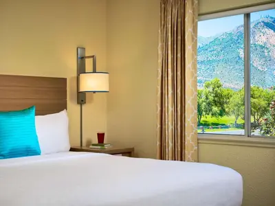 a hotel room with a bed and a large window at Sonesta Simply Suites Dublin Columbus in Dublin