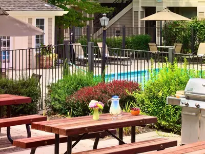 a picnic table with flowers on it next to a pool at Sonesta Simply Suites Dublin Columbus in Dublin