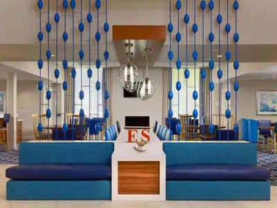 a lobby with blue couches and blue chairs at Sonesta Simply Suites Dublin Columbus in Dublin
