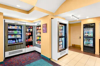a store aisle with two refrigerators and drinks at Sonesta ES Suites Charleston in Charleston