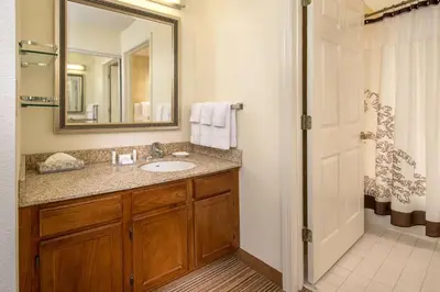 a bathroom with a sink and a mirror at Sonesta ES Suites Charleston in Charleston