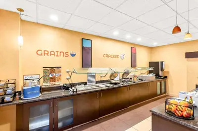 a large kitchen with a counter with food at Sonesta ES Suites Charleston in Charleston