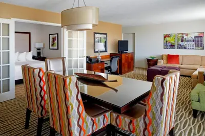 a living room with a table and chairs in a hotel room at Charleston Marriott Town Center in Charleston