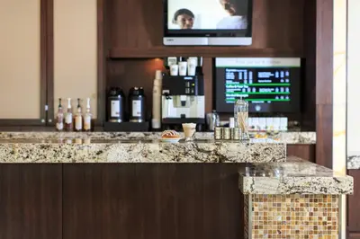 a bar in a hotel with a television above it at Charleston Marriott Town Center in Charleston