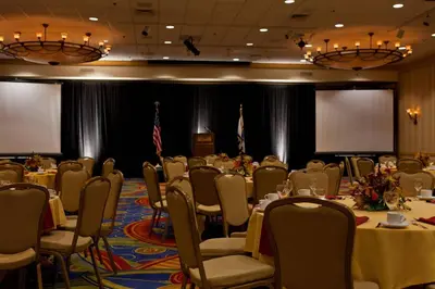 a conference room with tables and chairs and a podium at Charleston Marriott Town Center in Charleston