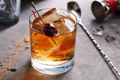 a drink with a cherry on a table at Courtyard Cincinnati Blue Ash in Blue Ash
