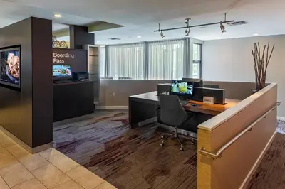 an office with a desk with a computer on it at Courtyard Cincinnati Blue Ash in Blue Ash