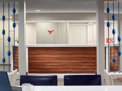 a meeting room with chairs and a wooden wall at Sonesta ES Suites Cincinnati - Blue Ash in Blue Ash