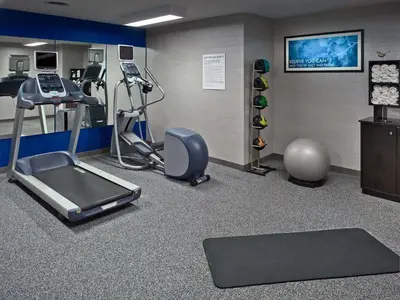 a fitness room with a treadmill and a gym at Sonesta ES Suites Cincinnati - Blue Ash in Blue Ash