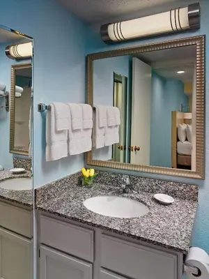 a bathroom with a sink and a mirror at Sonesta ES Suites Cincinnati - Blue Ash in Blue Ash